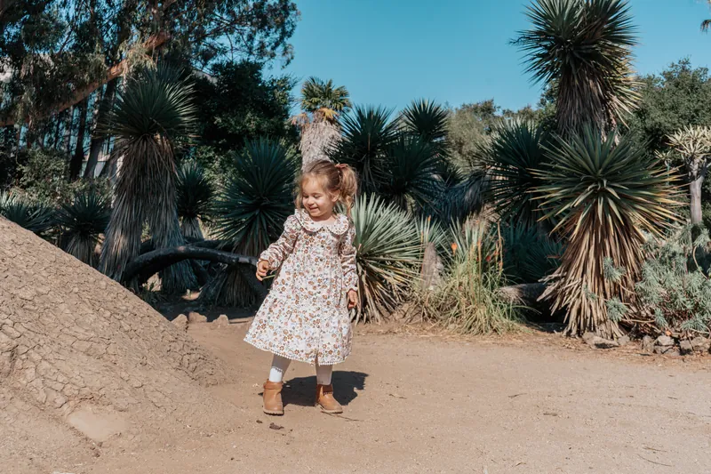 A little girl dancing in a desert garden