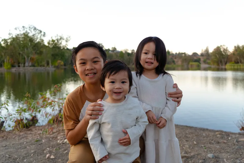 Three kids together by the lake