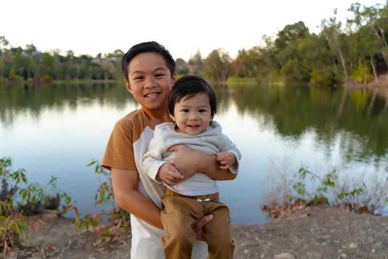 A big brother holding the baby