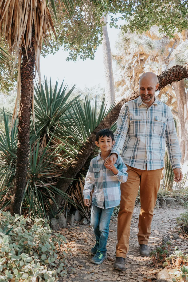 A dad and son walking hand in hand