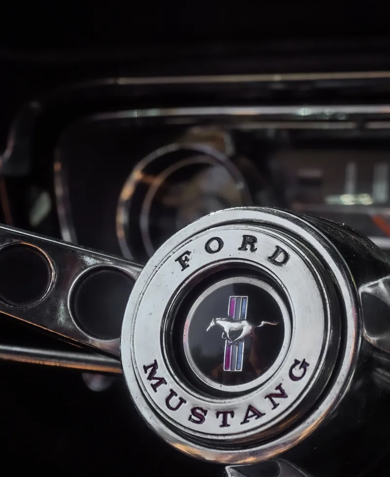 The steering wheel of a classic Ford Mustang