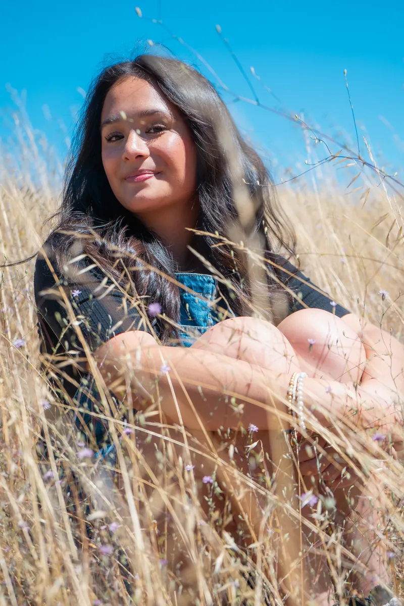 Sitting in tall golden grass