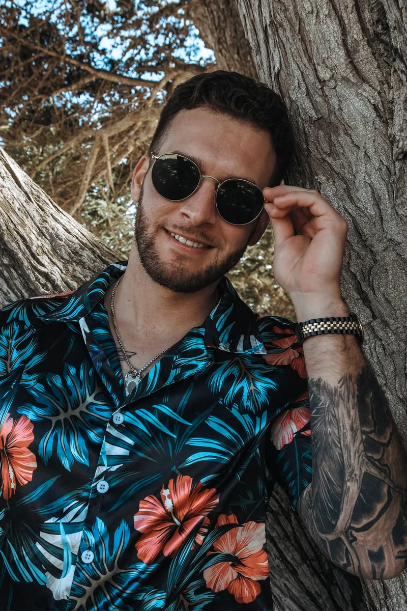 A close portrait at a cypress tree, sunglasses on