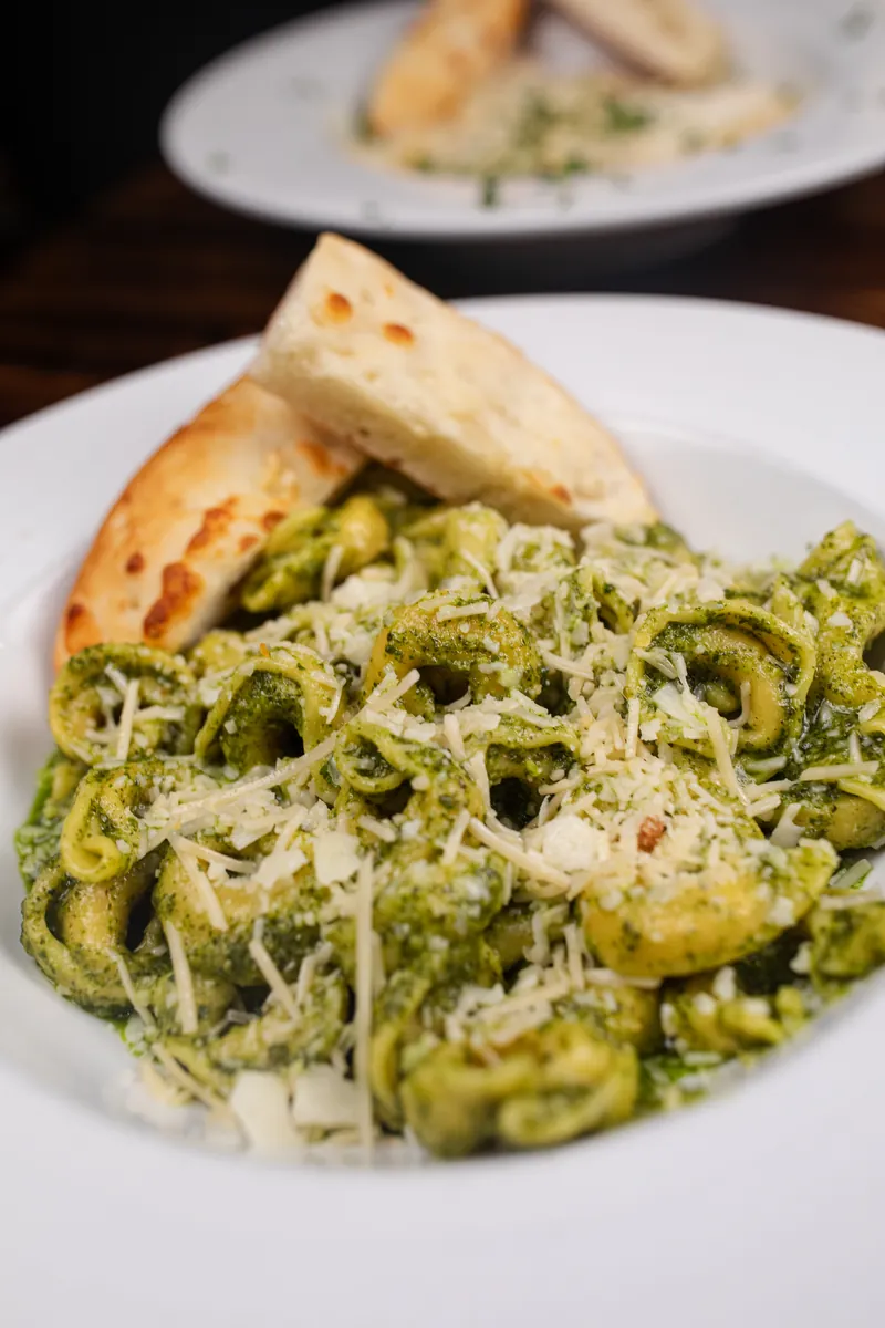 Pesto tortellini with parmesan and garlic bread