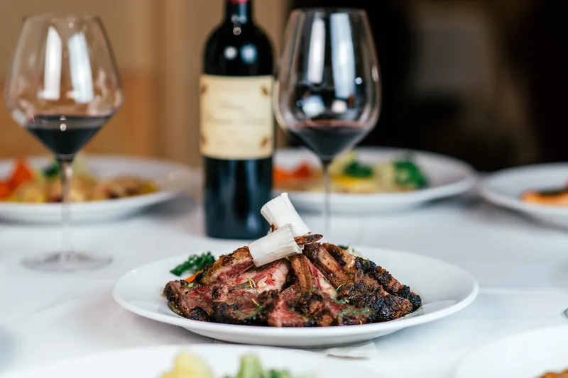 Sliced steak with a glass of red wine