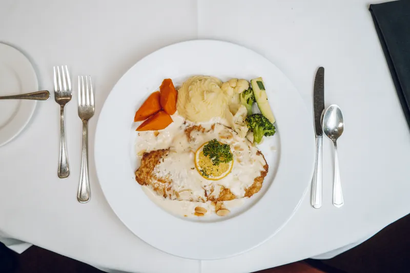 A plated entree with mashed potatoes and vegetables, from above