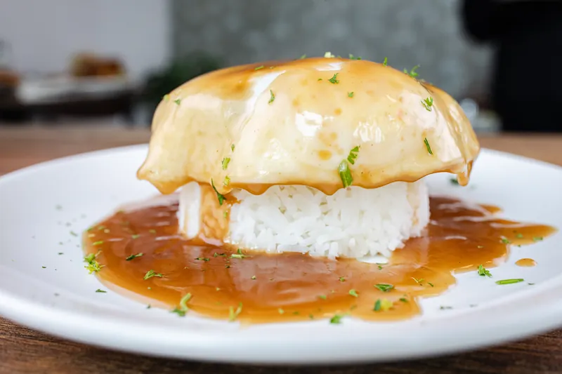 A rice plate with a fried egg and gravy
