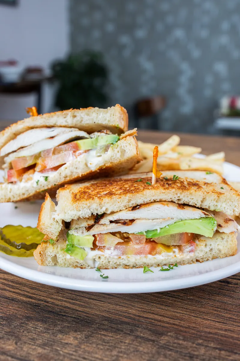 A grilled chicken sandwich with avocado